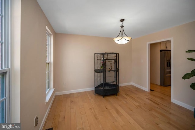 interior space featuring plenty of natural light, baseboards, and light wood-type flooring