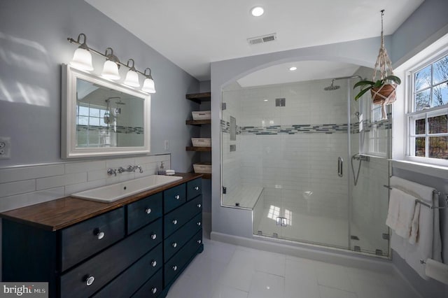 bathroom featuring visible vents, recessed lighting, a stall shower, and vanity