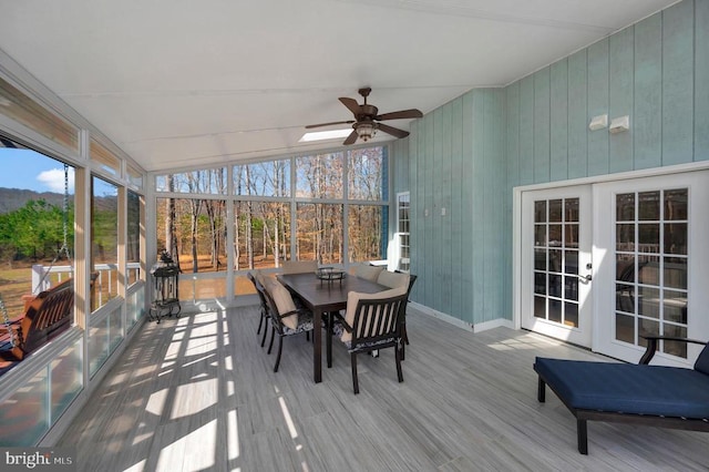 sunroom with a ceiling fan, vaulted ceiling, and french doors