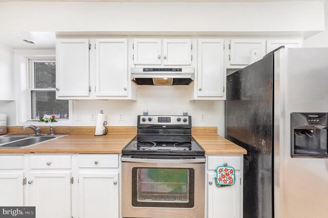 kitchen with light countertops, appliances with stainless steel finishes, white cabinetry, a sink, and ventilation hood