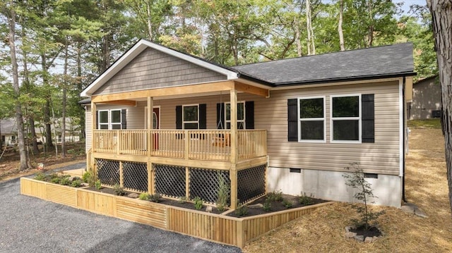 view of front of home featuring crawl space, a shingled roof, and a porch