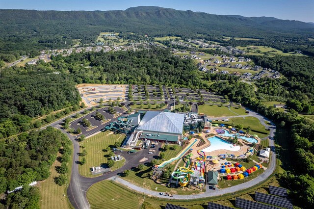 bird's eye view with a mountain view and a forest view