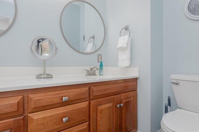 half bathroom with vanity and toilet