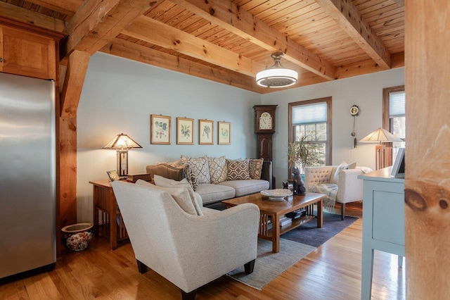 living area featuring light wood-type flooring, beam ceiling, and wooden ceiling