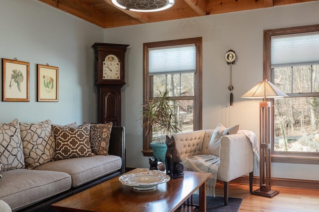 living room with beam ceiling and light wood-type flooring