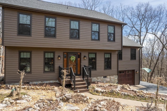 colonial home featuring crawl space, a garage, driveway, and a shingled roof