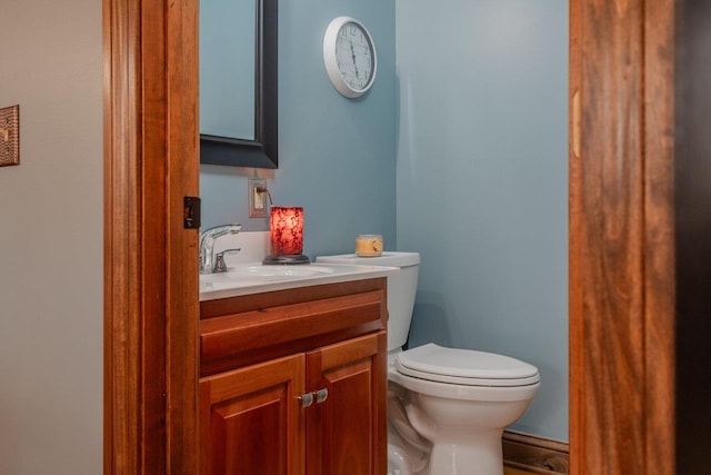 half bath featuring toilet and vanity