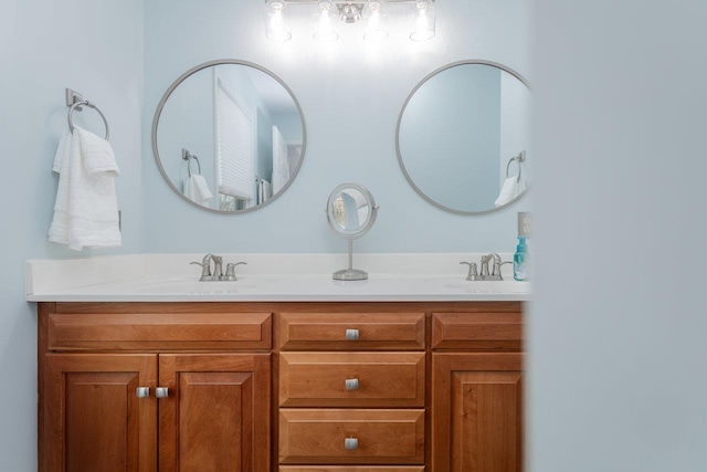 bathroom featuring a sink and double vanity