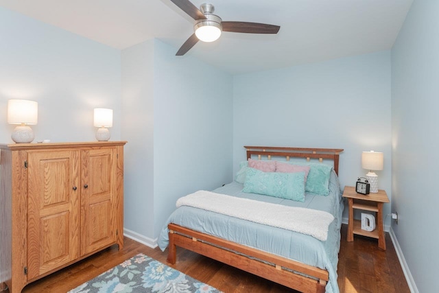 bedroom with ceiling fan, baseboards, and wood finished floors