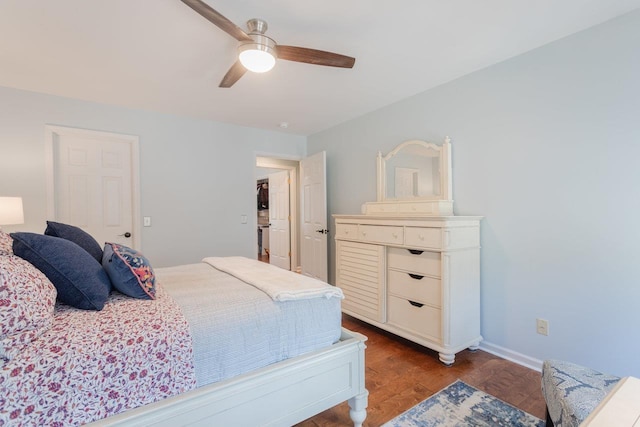 bedroom with baseboards, a ceiling fan, and wood finished floors