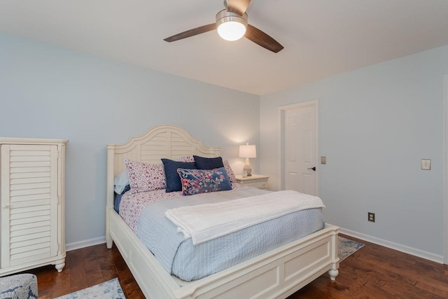 bedroom with a ceiling fan, wood finished floors, and baseboards