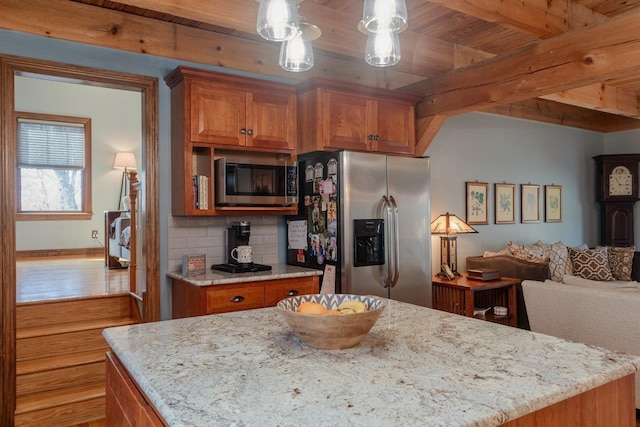 kitchen with beamed ceiling, tasteful backsplash, open floor plan, appliances with stainless steel finishes, and brown cabinetry