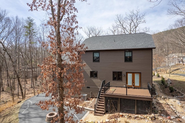 back of property with central AC unit, a wooden deck, a shingled roof, stairs, and french doors