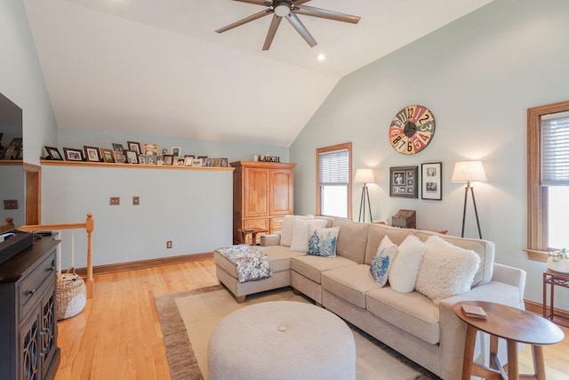 living room featuring ceiling fan, baseboards, lofted ceiling, and light wood-style floors