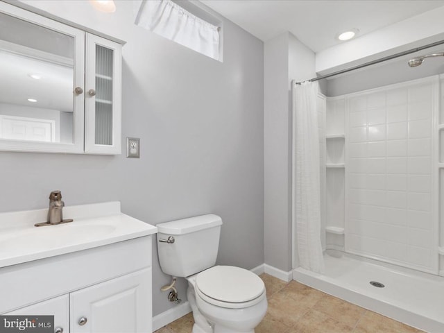 full bathroom featuring tile patterned floors, toilet, a stall shower, baseboards, and vanity