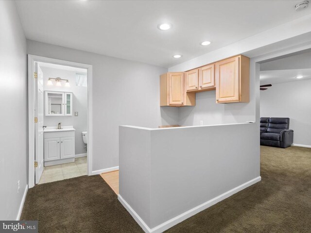 corridor featuring recessed lighting, baseboards, and light colored carpet