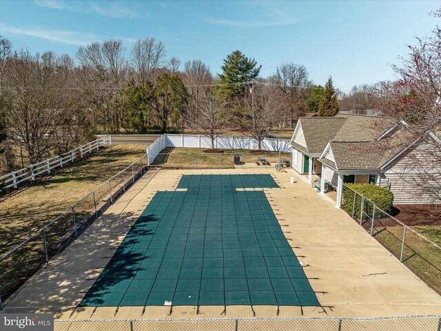 view of swimming pool with a patio area and fence