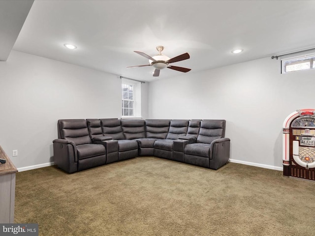 living room featuring baseboards, plenty of natural light, carpet, and ceiling fan