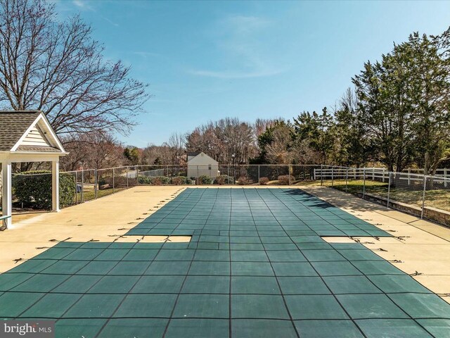 view of swimming pool with a fenced in pool, fence, and a patio area