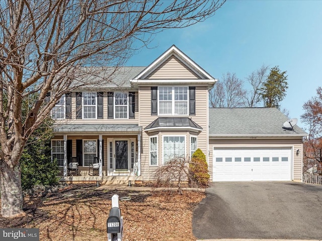 view of front of property with covered porch, driveway, an attached garage, and a shingled roof