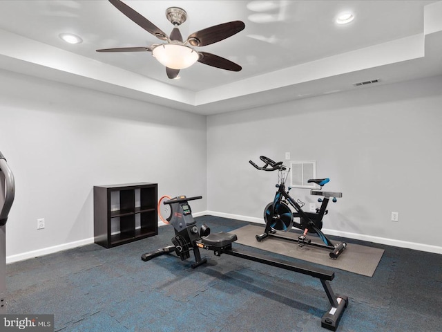 exercise area with a raised ceiling, recessed lighting, baseboards, and visible vents