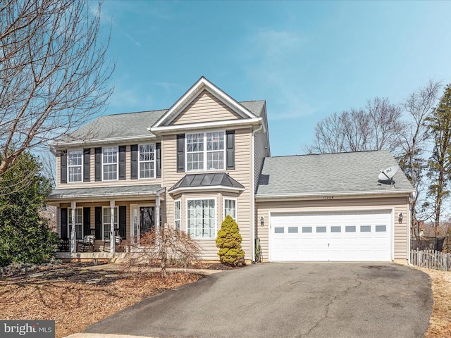 view of front of home with aphalt driveway, roof with shingles, covered porch, and an attached garage