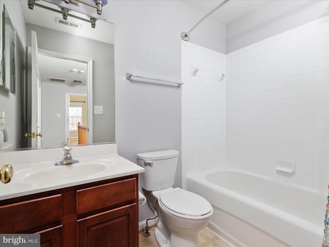 bathroom with vanity, toilet, visible vents, and shower / washtub combination