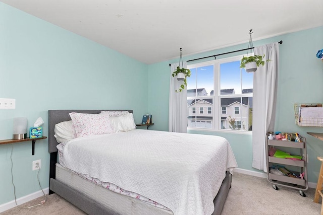 bedroom featuring light carpet