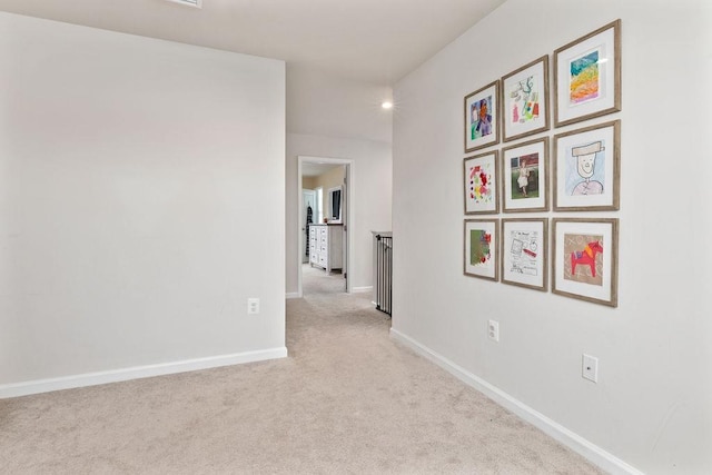 hallway featuring light carpet