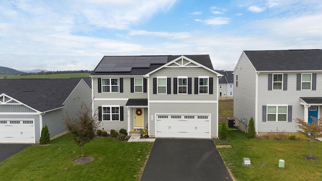 view of front of property with central air condition unit, a front lawn, and solar panels