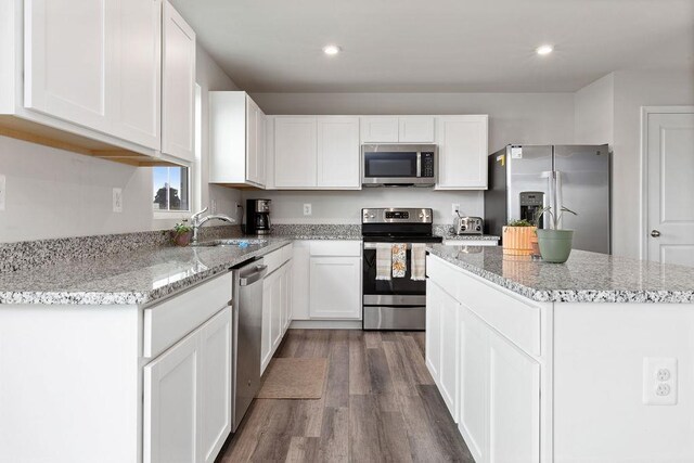 kitchen featuring white cabinetry, stainless steel appliances, and a center island