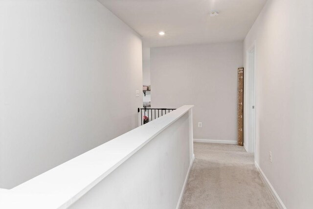 hallway with light colored carpet