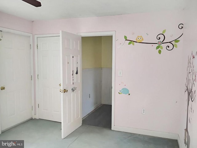 spare room featuring concrete floors and ceiling fan