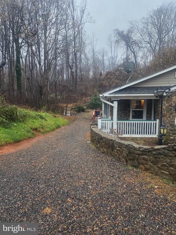 view of property exterior with a porch