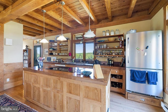 kitchen with freestanding refrigerator, open shelves, beamed ceiling, wooden ceiling, and a sink
