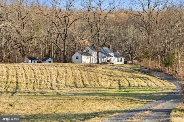 exterior space featuring a forest view