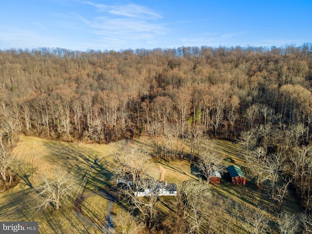 birds eye view of property with a view of trees