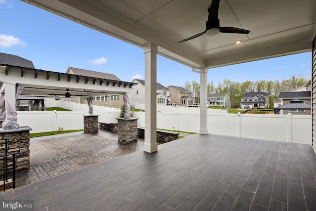 view of patio / terrace featuring a fenced backyard, a ceiling fan, and a residential view