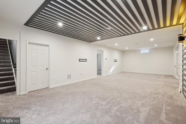 basement featuring visible vents, recessed lighting, carpet, and stairs