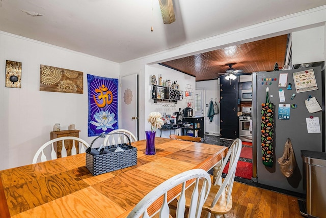 dining space featuring a ceiling fan and wood finished floors