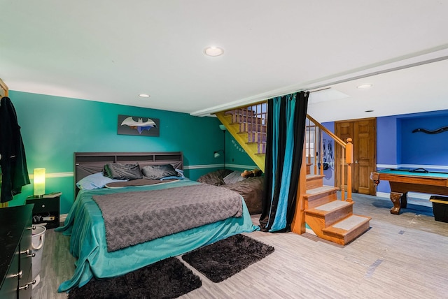 bedroom featuring baseboards, wood finished floors, and recessed lighting