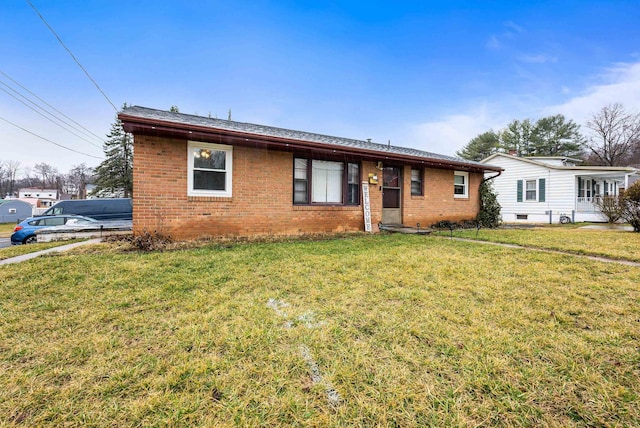 ranch-style home featuring brick siding and a front lawn