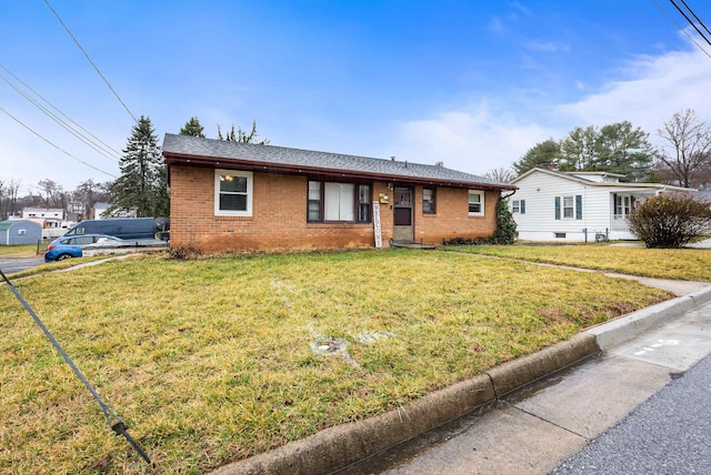 single story home featuring a front yard and brick siding