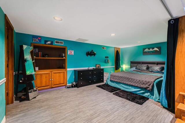 bedroom with recessed lighting, visible vents, and wood finished floors