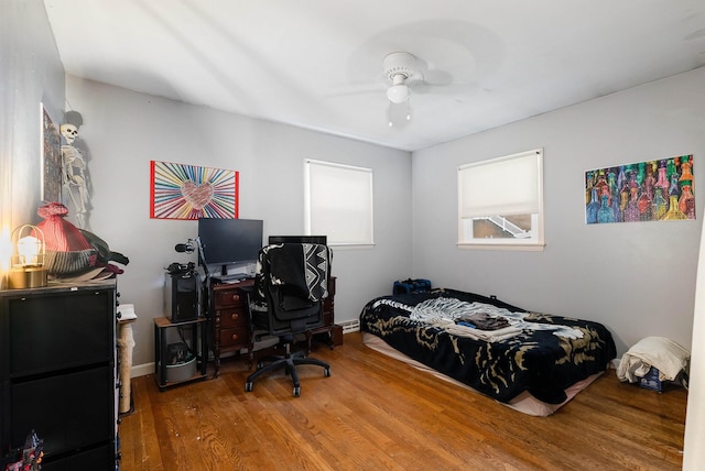 bedroom with ceiling fan and wood finished floors