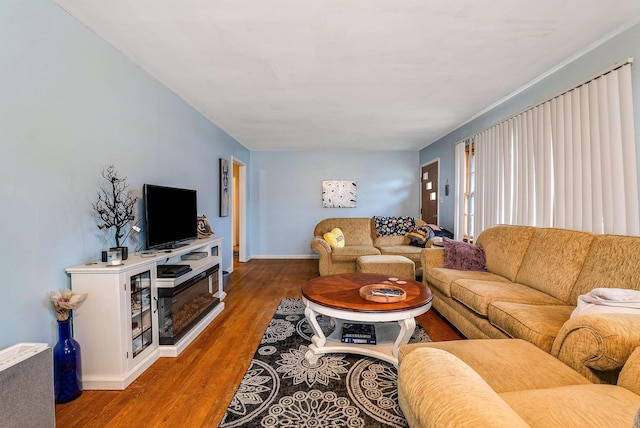 living area with wood finished floors and baseboards