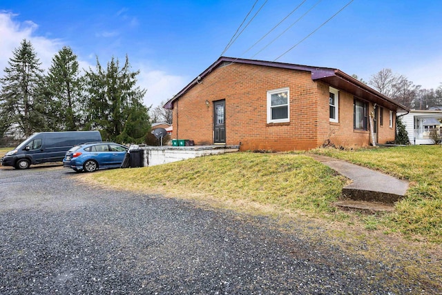 view of home's exterior featuring a yard and brick siding