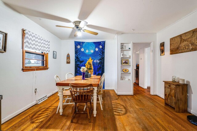 dining space featuring visible vents, ceiling fan, baseboards, and wood finished floors