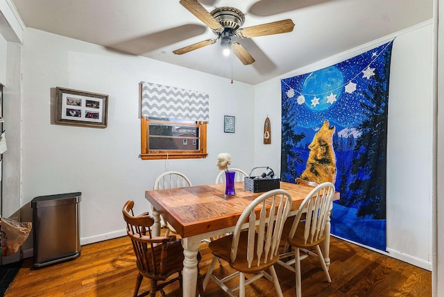 dining room with baseboards, a ceiling fan, and wood finished floors