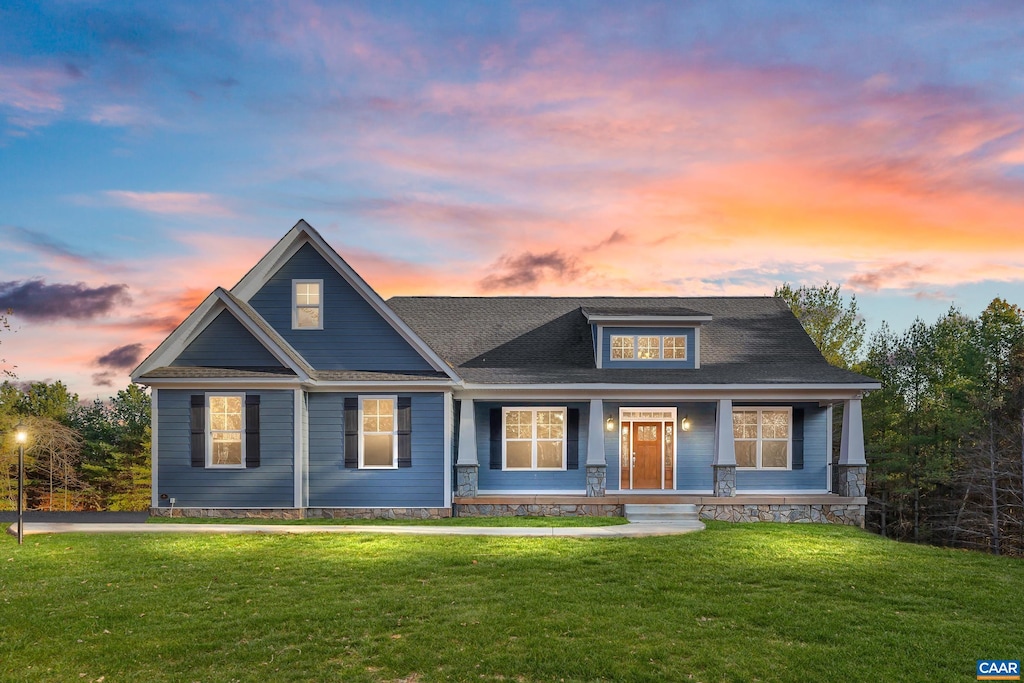 craftsman house with a porch and a front lawn